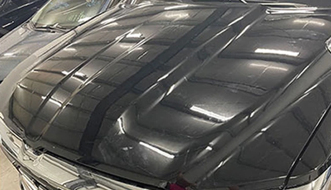 Dark hood with damage marked before repair, after repair — Alpha Hail Repair, Springfield, Missouri